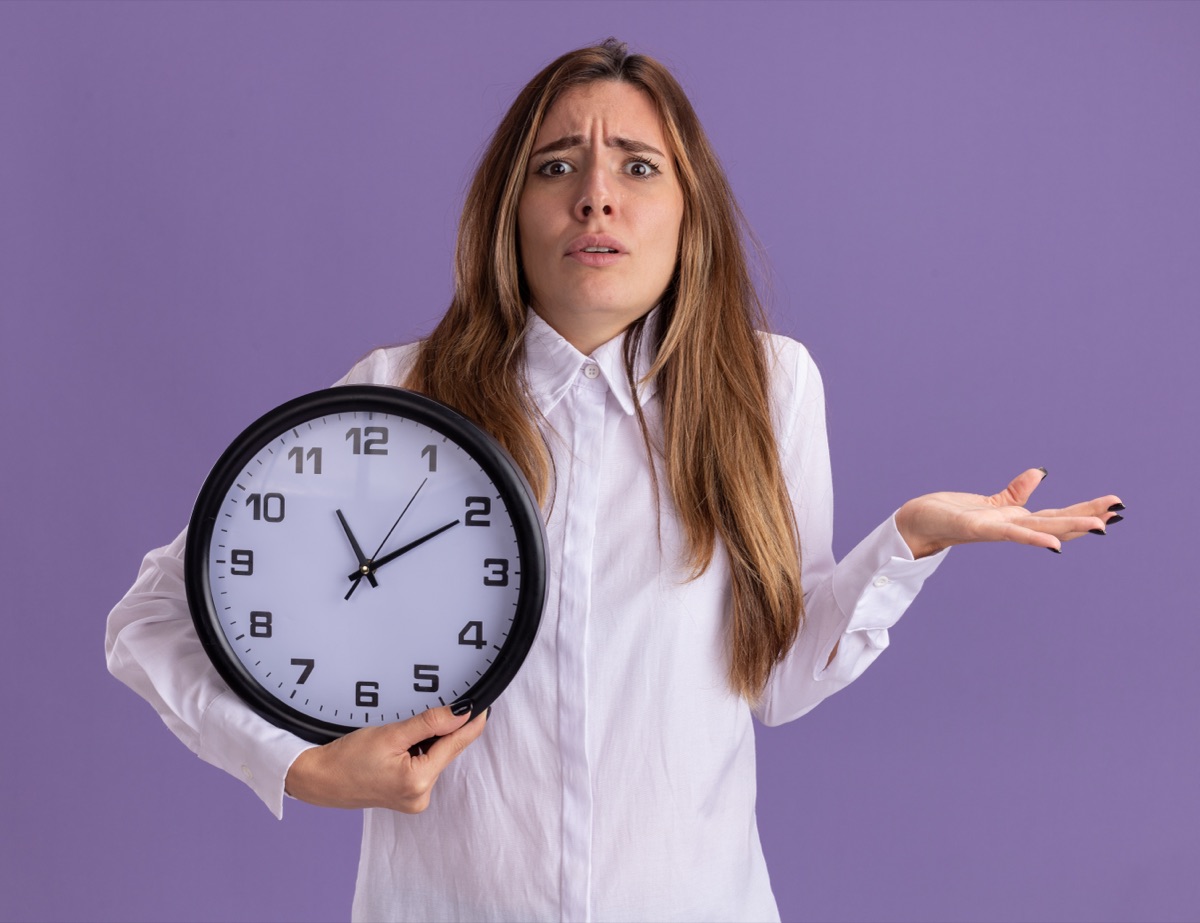 Confused worker checking a clock