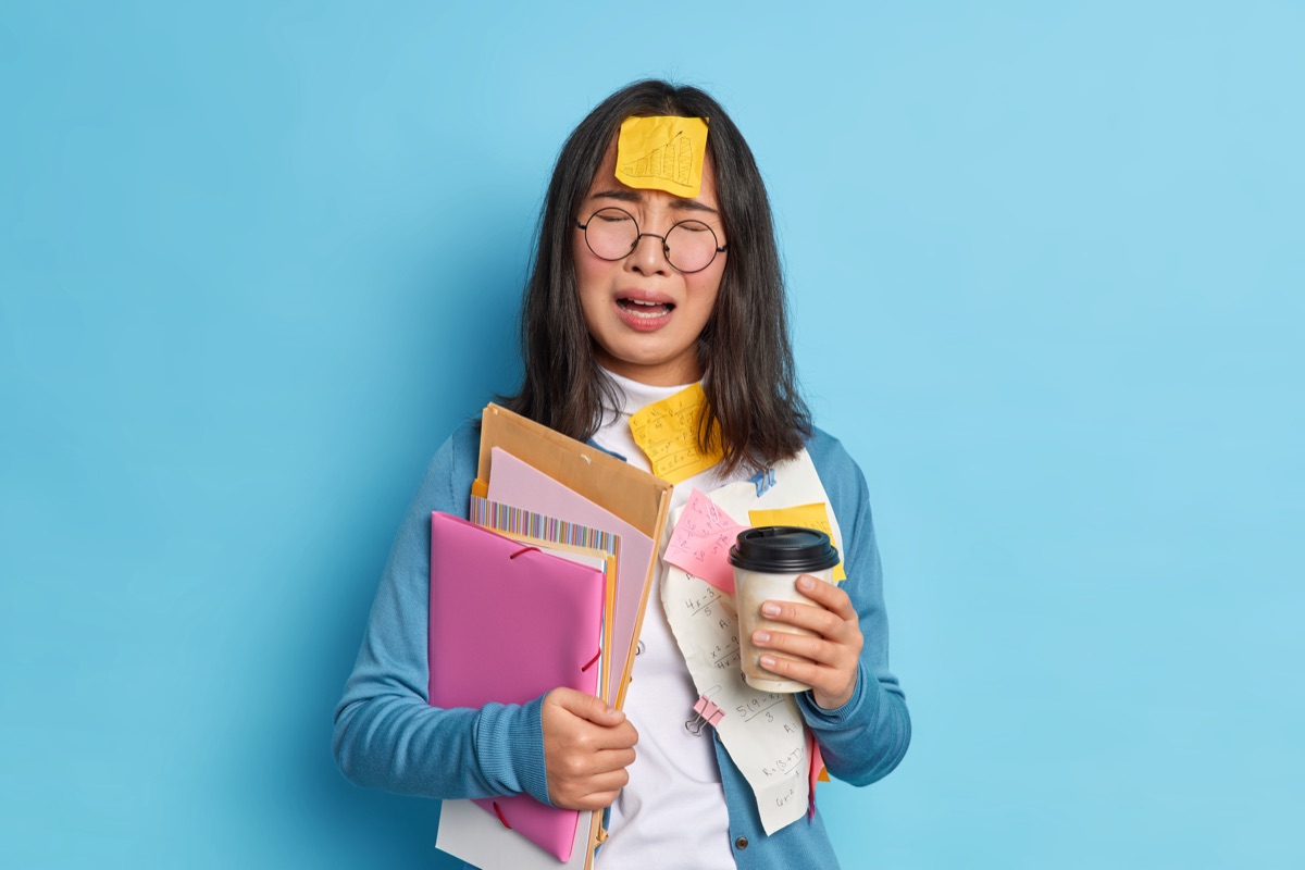 Frustrated worker buried in sticky notes